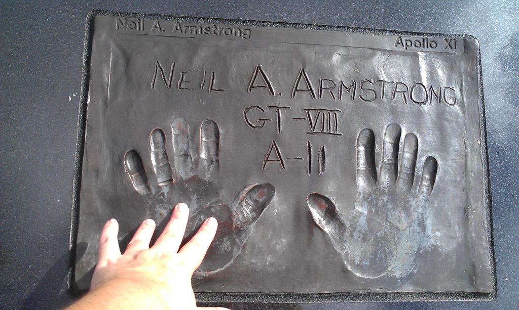 Stacey Severn touching the plaque with Neil Armstrong's hand prints 