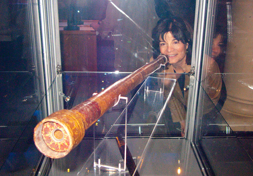 Photo of Carolyn Porco inspecting one of Galileo's telescopes in Stockholm, Sweden, 2009