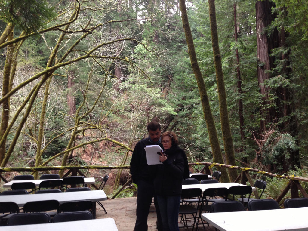 Photo of Neil deGrasse Tyson and Ann Druyan reviewing script on location, taken by Sarah Mozal.