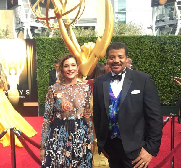 Photo of StarTalk Executive Producers Helen Matsos and Neil deGrasse Tyson on the red carpet at the 2015 Emmys.
