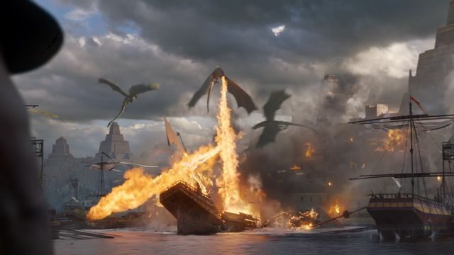 Screen capture from HBO's "Game of Thrones" showing fire-breathing dragons attacking the slave-master's fleet.