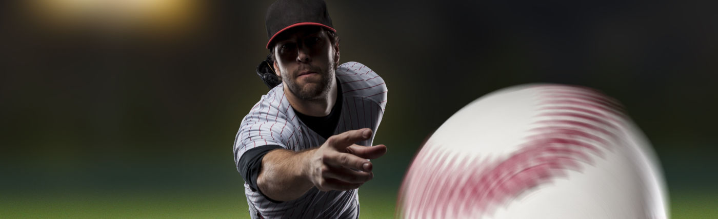 Batters-eye-view of pitcher throwing baseball, by AlbertoChagas/iStock.