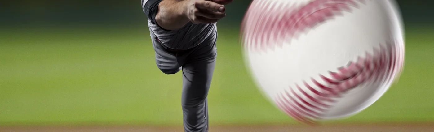 Batters-eye-view of pitcher throwing baseball, by AlbertoChagas/iStock.