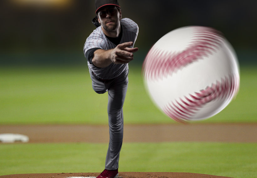 Batters-eye-view of pitcher throwing baseball, by AlbertoChagas/iStock.
