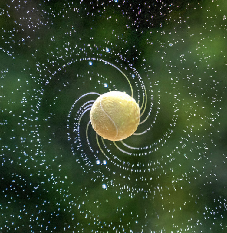 Photo of tennis ball showing spin. Credit: Zyteng-Photography/iStock.