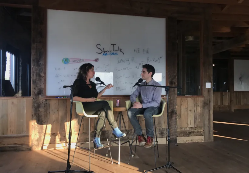 Ben Ratner’s photo of Janna Levin and Matt Kirshen in front of the white board.
