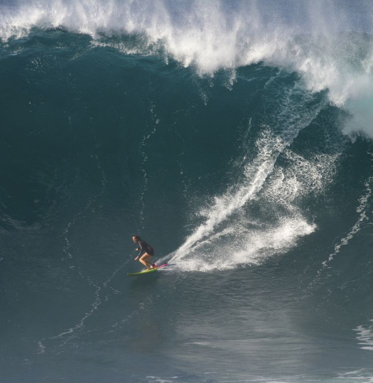 A photo by Erik Aeder of Paige Alms surfing a big wave, courtesy of www.paigealms.com