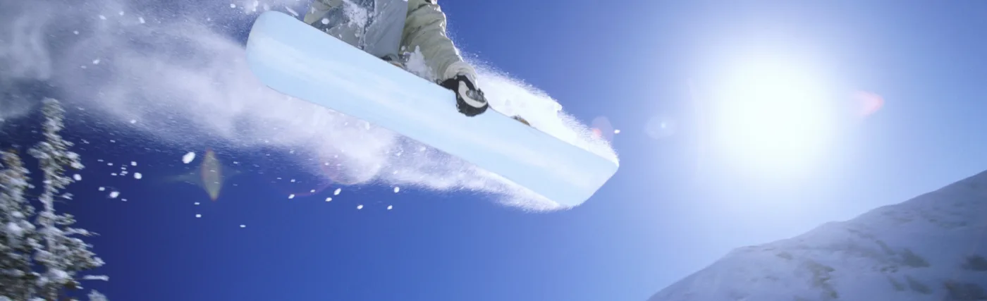 Photograph of a snowboader in a mid-air jump for a StarTalk Playing with Science episode about snowboarding. Credit: Digital Vision.