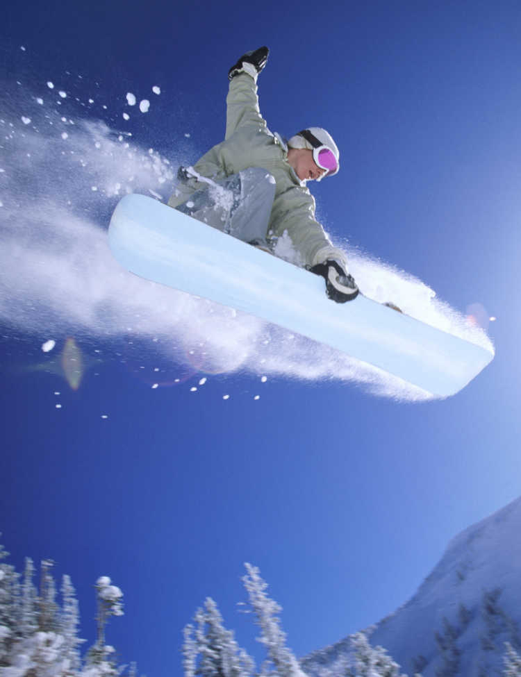 Photograph of a snowboader in a mid-air jump for a StarTalk Playing with Science episode about snowboarding. Credit: Digital Vision.