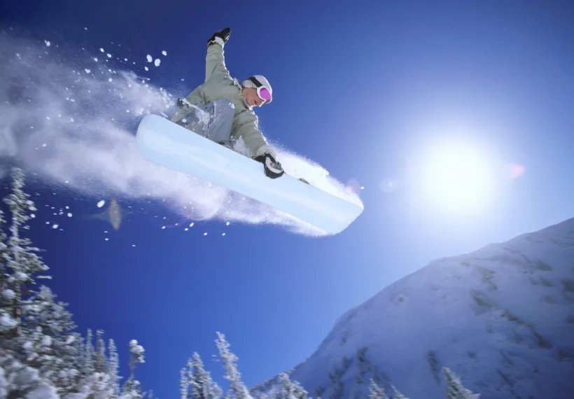 Photograph of a snowboader in a mid-air jump for a StarTalk Playing with Science episode about snowboarding. Credit: Digital Vision.