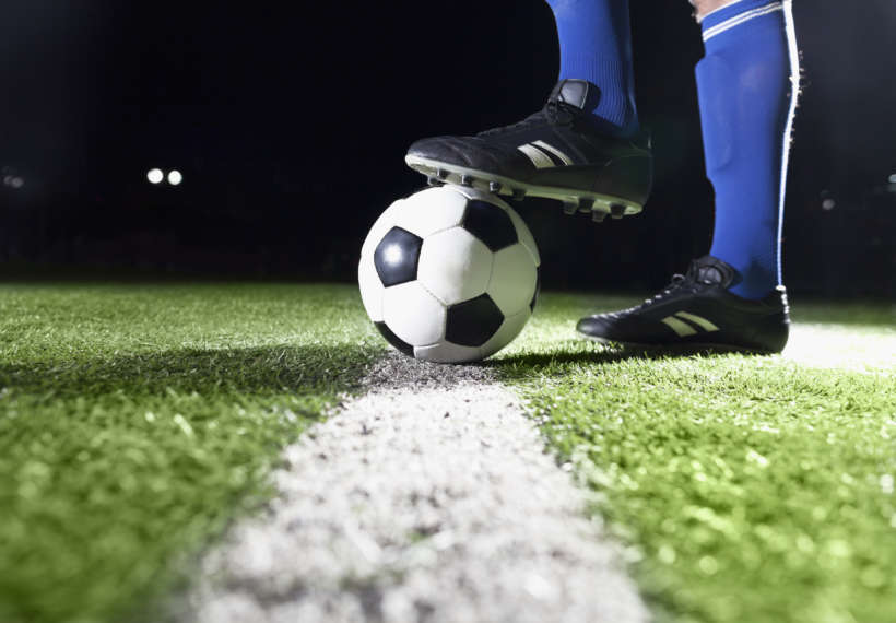 Photo for planet soccer showing soccer player’s foot and soccer ball. Credit: XiXinXing/iStock.