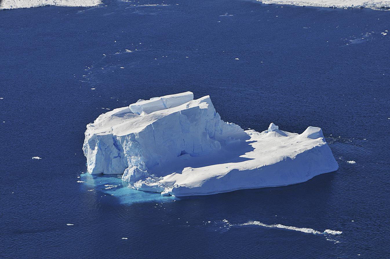 Photo of an iceberg floating on the open ocean. Image credit: NASA/Jane Peterson.