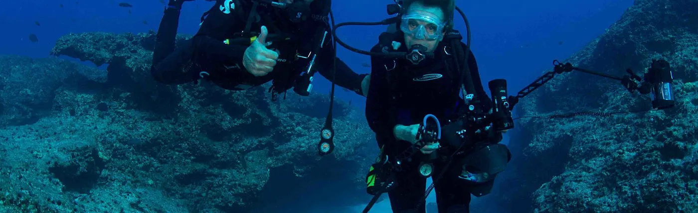 Dr. Sylvia Earle and marine artist Wyland share their first dive together at Midway Atoll National Wildlife Refuge. Photo credit: Amanda Meyer/USFWS
