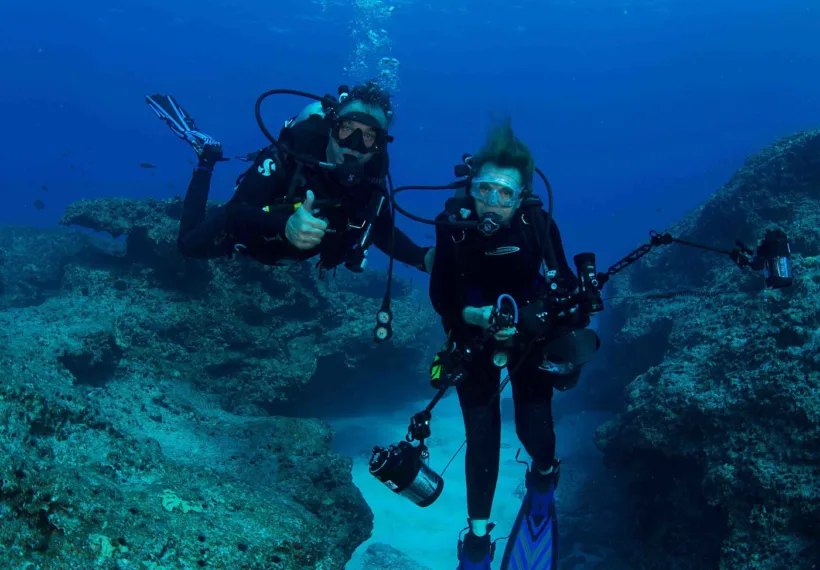 Dr. Sylvia Earle and marine artist Wyland share their first dive together at Midway Atoll National Wildlife Refuge. Photo credit: Amanda Meyer/USFWS