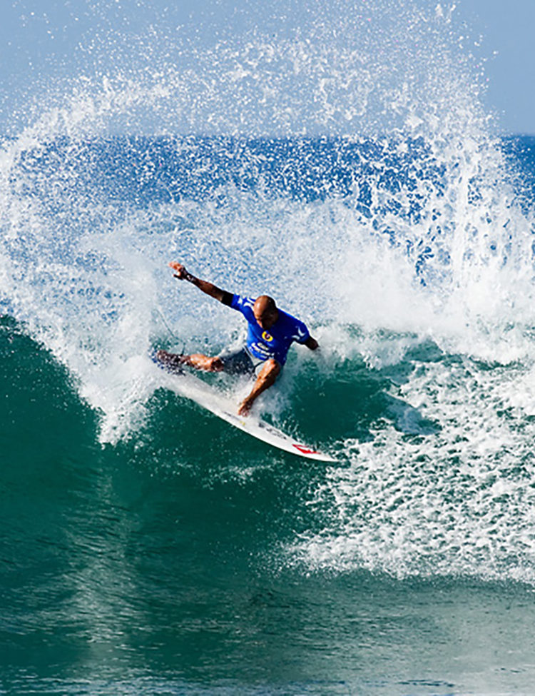 Rob Keaton’s photo of Kelly Slater riding a wave, via Wikimedia Commons.