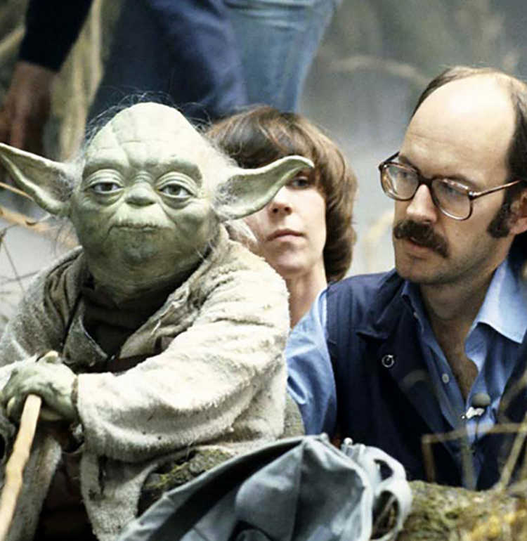 Photo of Yoda, Kathryn Mullen and Frank Oz on the set of "The Empire Strikes Back", via muppet.wikia.com [CC BY-SA 3.0 (https://creativecommons.org/licenses/by-sa/3.0).
