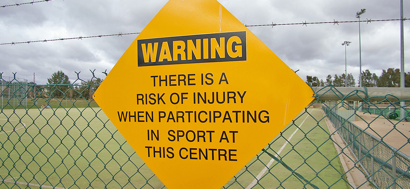 Photo of sports injuries warning sign, by Bidgee via Wikimedia Commons.