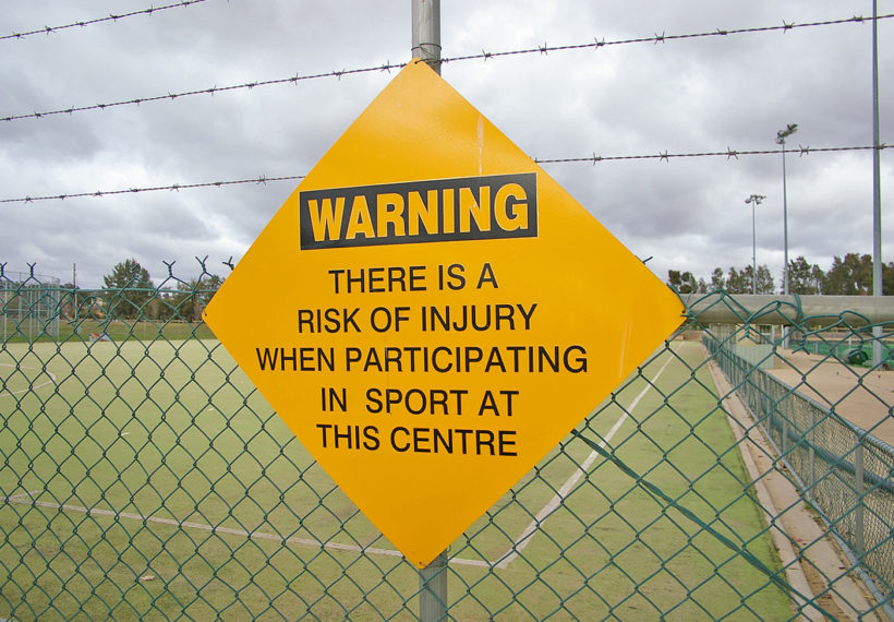 Photo of sports injuries warning sign, by Bidgee via Wikimedia Commons.