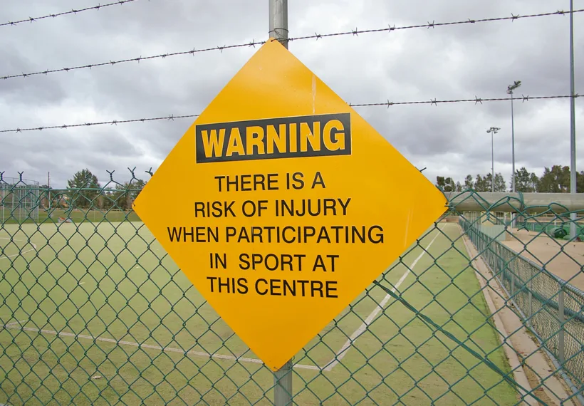 Photo of sports injuries warning sign, by Bidgee via Wikimedia Commons.