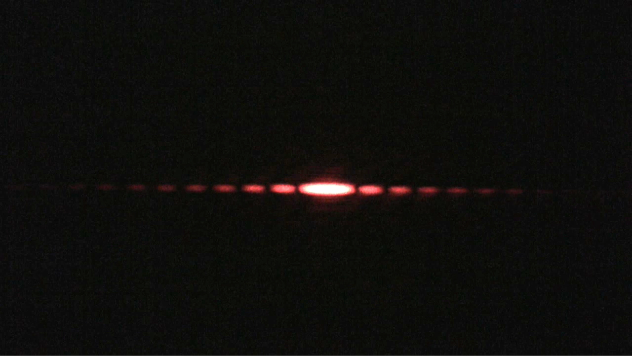 The pattern produced by single slit diffraction of red laser light. Source: MIT.