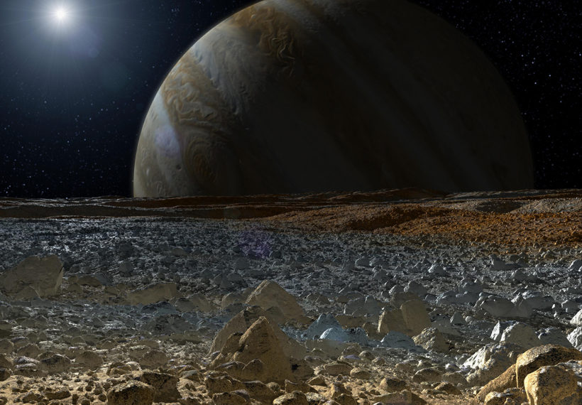 An Artist’s Rendering of Europa’s Surface as Jupiter Looms in the Background. Credit: NASA/JPL-Caltech.