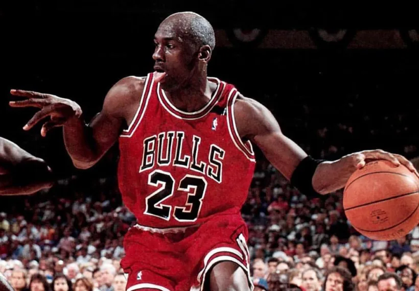 Michael Jordan dribbling on the court for the Chicago Bulls. Image Credit: Unknown author – Public domain.