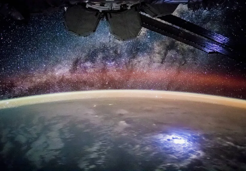 NASA’s photo from the International Space Station with a lightning storm on Earth below and the Milky Way above, taken by the Expedition 44 crew.
