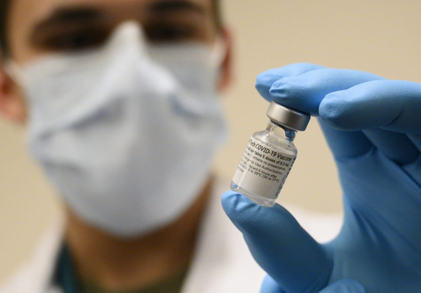U.S Secretary of defense’s photo of Army Spc. Angel Laureano holds a vial of the COVID-19 vaccine, Walter Reed National Military Medical Center, Bethesda, Md., Dec. 14, 2020. (DoD photo by Lisa Ferdinando)