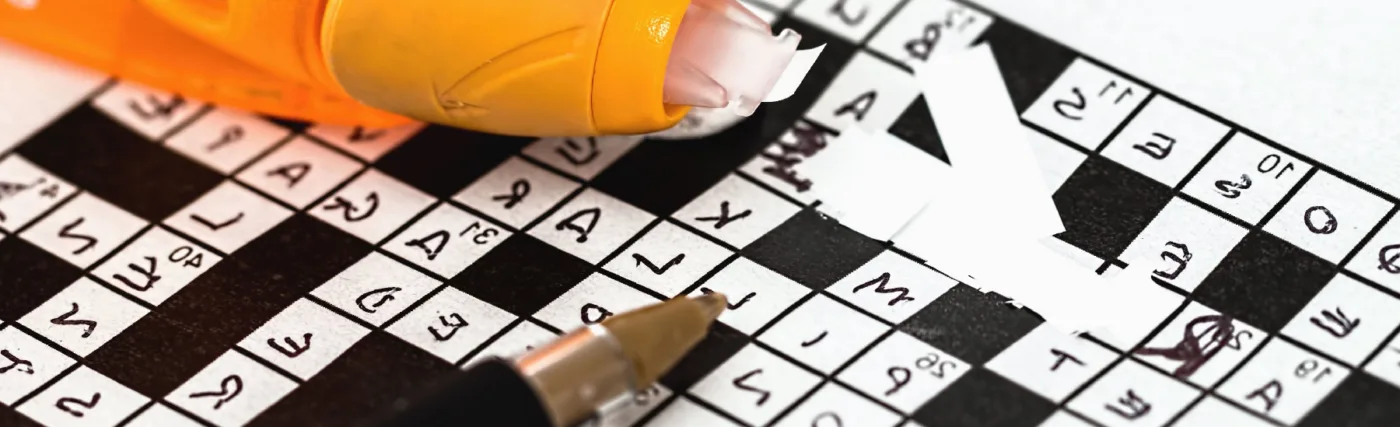 Photo of glasses on newspaper with crossword puzzle