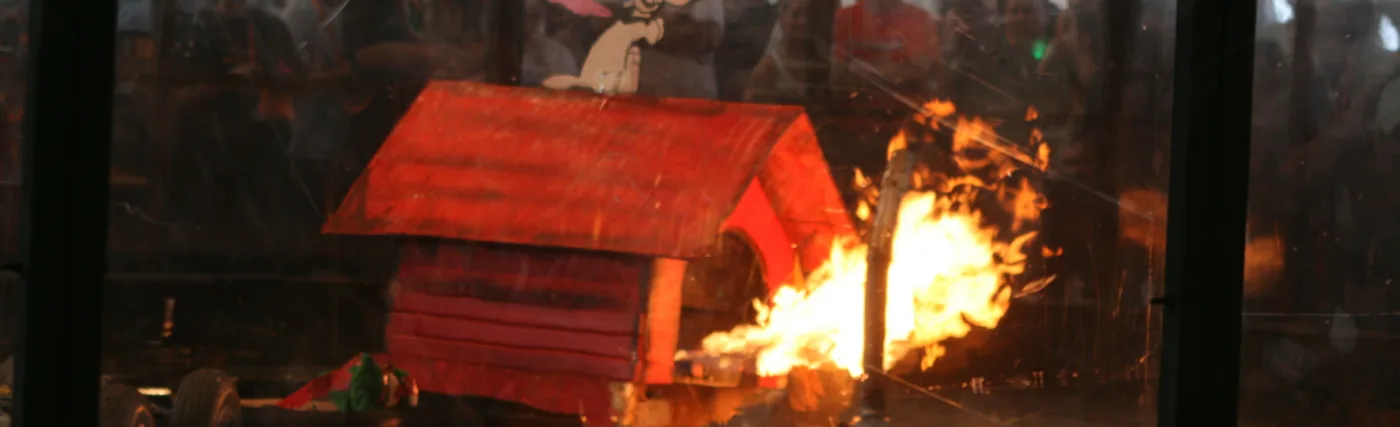 Robot combat involving a flame-enabled robot (left) and a "shredder" robot (right).