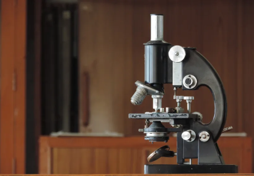 A compound microscope in a Biology lab.
