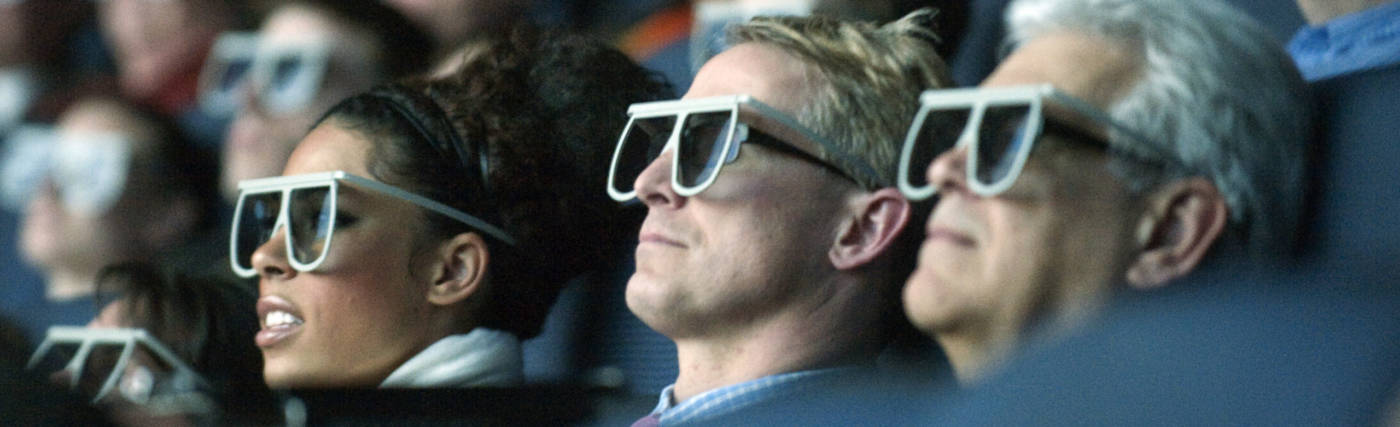 Moviegoers wear 3D glasses as they watch the world premiere of "Hubble 3D," screened at the Smithsonian's Air and Space Museum