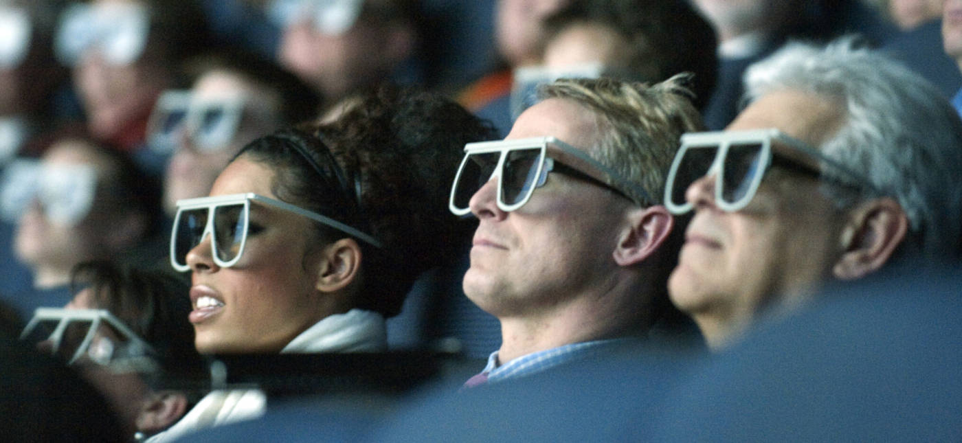 Moviegoers wear 3D glasses as they watch the world premiere of "Hubble 3D," screened at the Smithsonian's Air and Space Museum