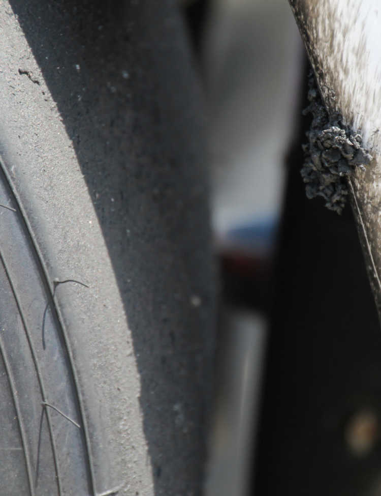 Detail on a tire and car (Helio Castroneves) after the 99th running of the Indianapolis 500