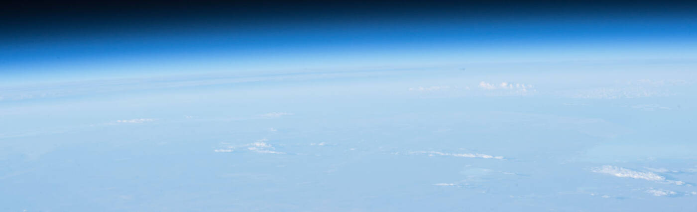 The Moon, the Earth's limb and thin blue atmosphere are seen in this photograph taken by an Expedition 51 crew member.