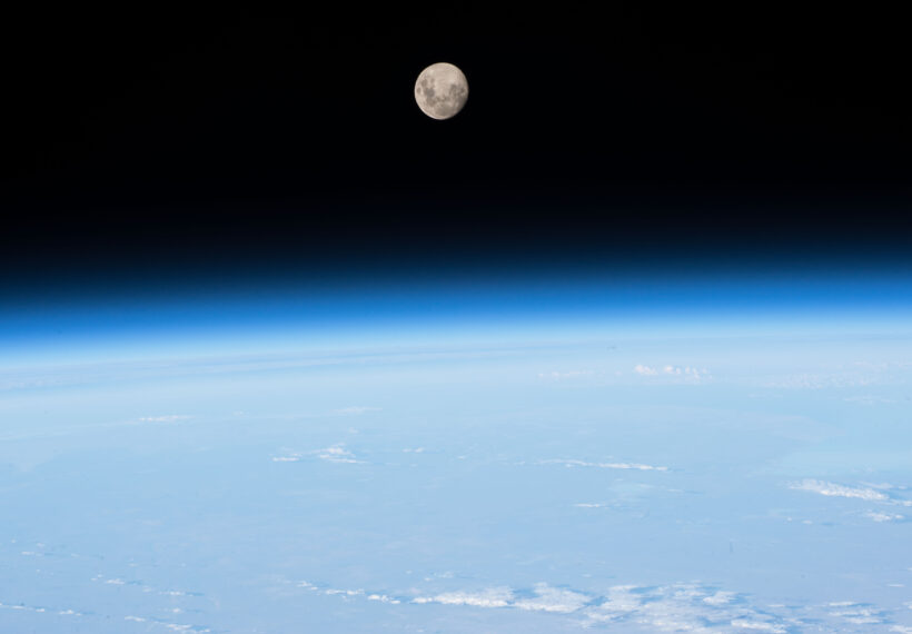 The Moon, the Earth's limb and thin blue atmosphere are seen in this photograph taken by an Expedition 51 crew member.
