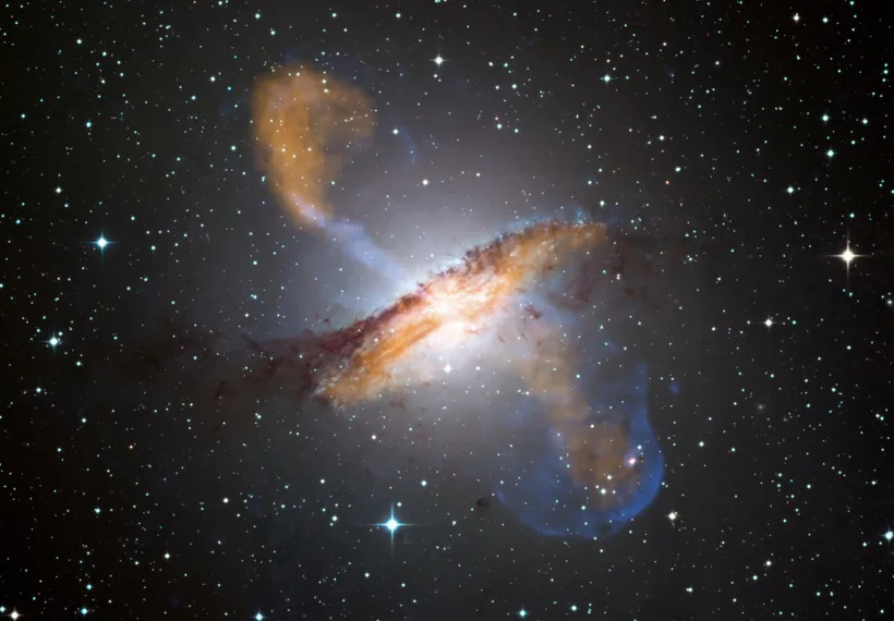 This image of Centaurus A shows a spectacular new view of a supermassive black hole's power. Jets and lobes powered by the central black hole in this nearby galaxy are shown by submillimeter data (colored orange) from the Atacama Pathfinder Experiment (APEX) telescope in Chile and X-ray data (colored blue) from the Chandra X-ray Observatory. Visible light data from the Wide Field Imager on the Max-Planck/ESO 2.2 m telescope, also located in Chile, shows the dust lane in the galaxy and background stars. The X-ray jet in the upper left extends for about 13,000 light years away from the black hole. The APEX data shows that material in the jet is travelling at about half the speed of light.