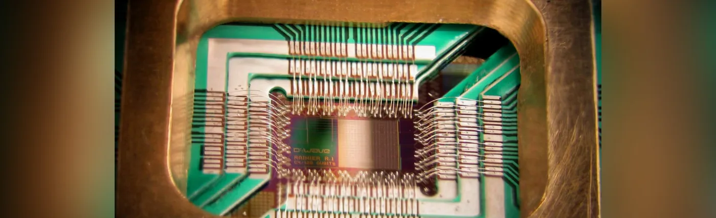 Photograph of a chip constructed by D-Wave Systems Inc. designed to operate as a 128-qubit superconducting adiabatic quantum optimization processor, mounted in a sample holder.