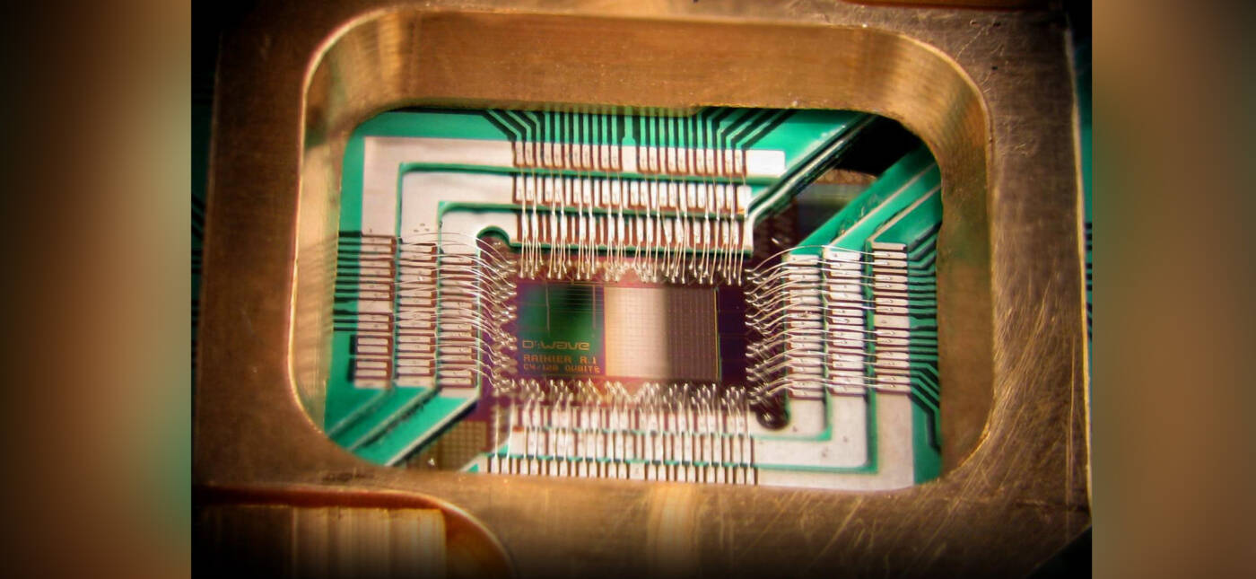 Photograph of a chip constructed by D-Wave Systems Inc. designed to operate as a 128-qubit superconducting adiabatic quantum optimization processor, mounted in a sample holder.