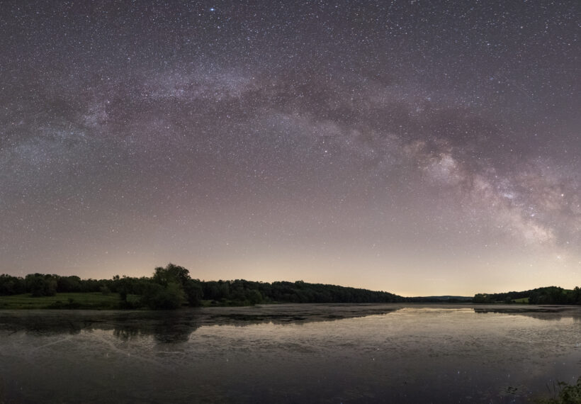 Panorama of the Milky Way galactic plane stretching over Bontecou Lake in Dutchess County, New York.