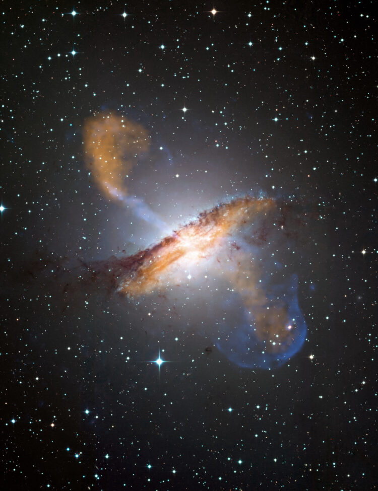 This image of Centaurus A shows a spectacular new view of a supermassive black hole's power. Jets and lobes powered by the central black hole in this nearby galaxy are shown by submillimeter data (colored orange) from the Atacama Pathfinder Experiment (APEX) telescope in Chile and X-ray data (colored blue) from the Chandra X-ray Observatory.