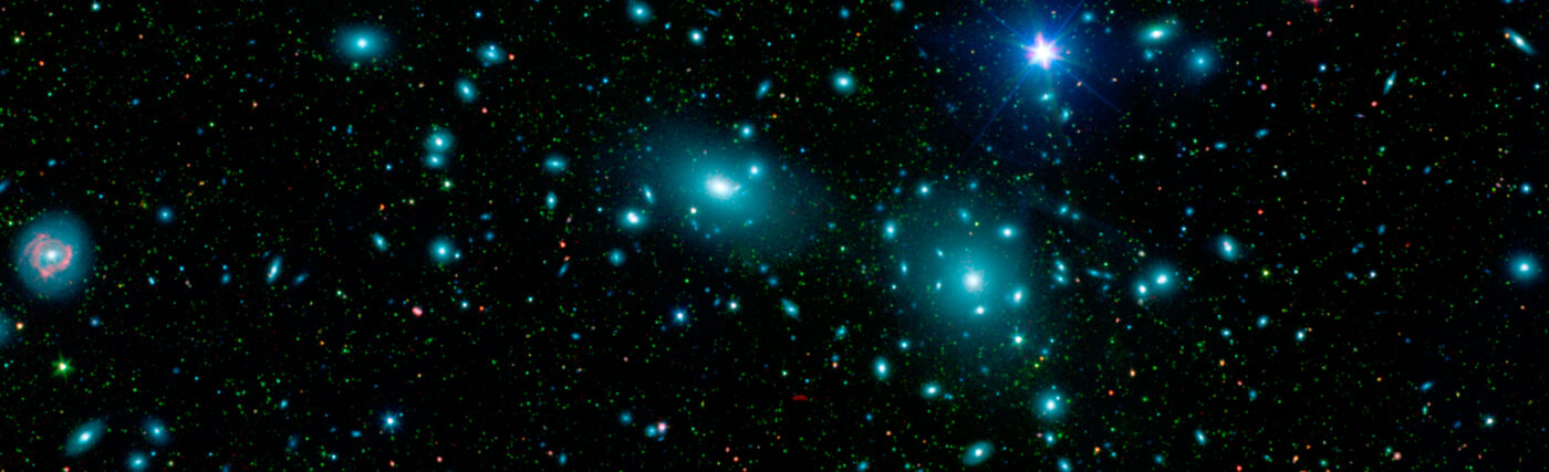 This false-color mosaic of the central region of the Coma cluster combines infrared and visible-light images to reveal thousands of faint objects (green). Follow-up observations showed that many of these objects, which appear here as faint green smudges, are dwarf galaxies belonging to the cluster. Two large elliptical galaxies, NGC 4889 and NGC 4874, dominate the cluster's center. The mosaic combines visible-light data from the Sloan Digital Sky Survey (color coded blue) with long- and short-wavelength infrared views (red and green, respectively) from NASA's Spitzer Space Telescop
