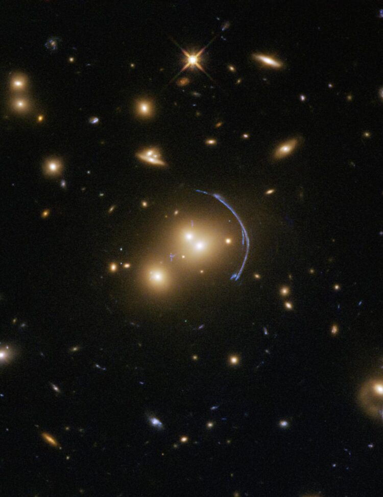 This Hubble Space Telescope image demonstrates the immense effects of gravity; more specifically, it shows the effects of gravitational lensing caused by a cluster of galaxies called SDSS J1152+3313. Gravitational lenses possess immense masses that warp their surroundings and bend the light from faraway objects into rings, arcs, streaks, blurs, and other odd shapes.
