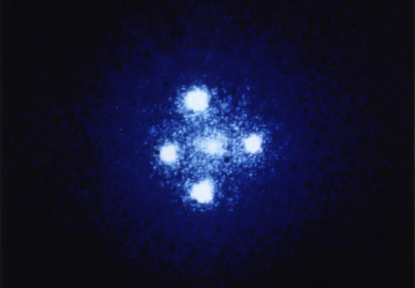 The European Space Agency's Faint Object Camera on board NASA's Hubble Space Telescope has provided astronomers with the most detailed image ever taken of the gravitational lens G2237 + 0305 — sometimes referred to as the Einstein Cross. The photograph shows four images of a very distant quasar which has been multiple-imaged by a relatively nearby galaxy acting as a gravitational lens. The angular separation between the upper and lower images is 1.6 arcseconds.