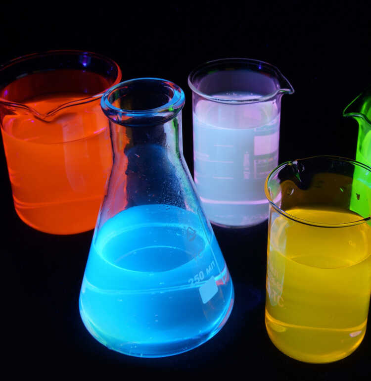 On this picture you can see fluorescence of different substances under UV light. Green is a fluorescein, red is Rhodamine B, yellow is Rhodamine 6G, blue is quinine, purple is a mixture of quinine and rhodamine 6g. Solutions are about 0.001% concentration in water.