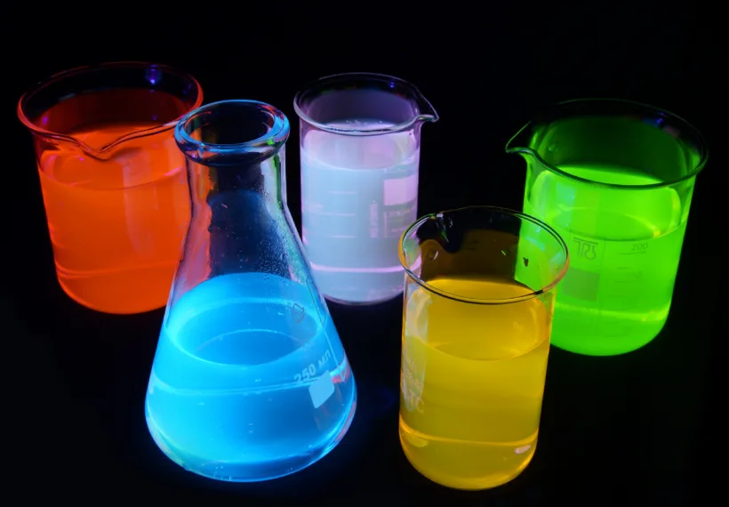 On this picture you can see fluorescence of different substances under UV light. Green is a fluorescein, red is Rhodamine B, yellow is Rhodamine 6G, blue is quinine, purple is a mixture of quinine and rhodamine 6g. Solutions are about 0.001% concentration in water.