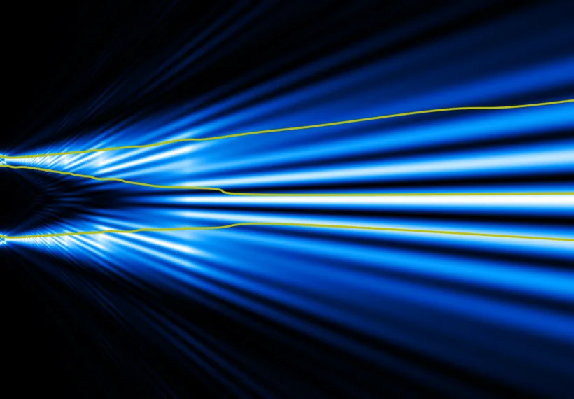 3 trajectories of electrons for the two-slit experiment. Each electron is guided by its wave function. While each trajectory passes through only one slit, the wave passes through both.