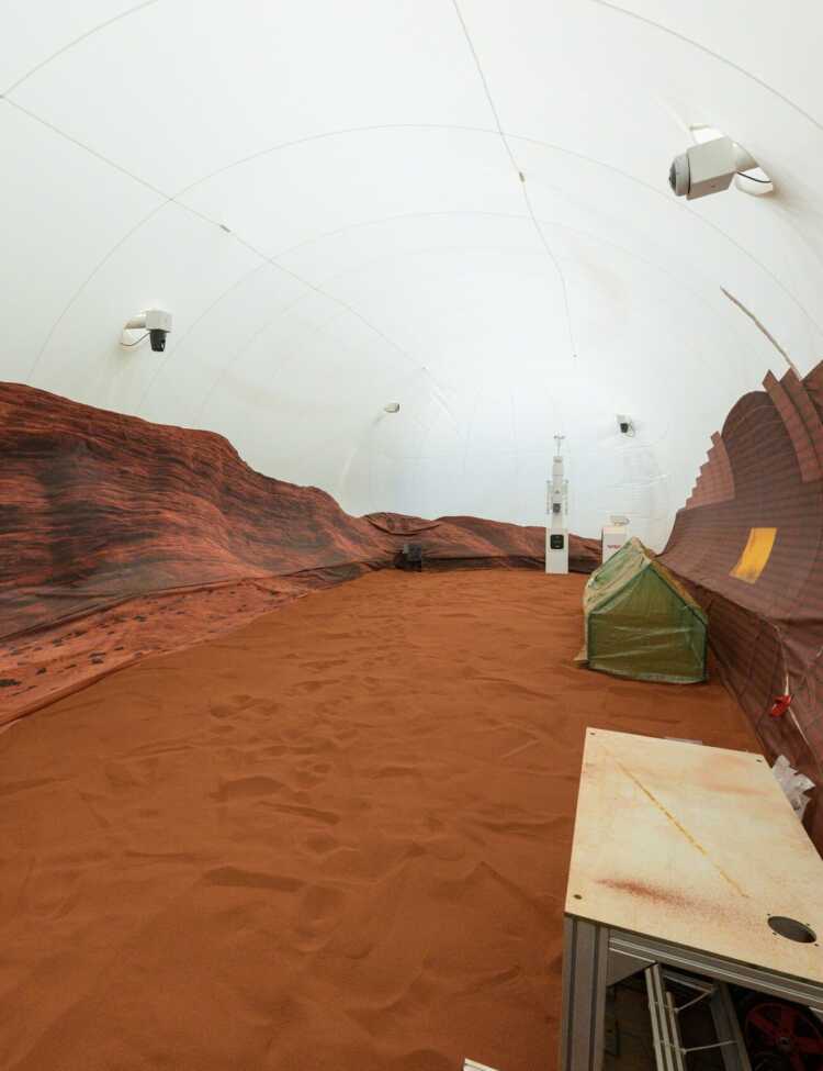 NASA’s simulated Mars habitat includes a 1,200-square-foot sandbox with red sand to simulate the Martian landscape. The area will be used to conduct simulated spacewalks or “Marswalks” during the analog missions. PHOTO DATE: 11-30-22 LOCATION: Bldg. 220 - CHAPEA SUBJECT: Photography of Crew Health and Performance Exploration Analog (CHAPEA) facility PHOTOGRAPHER: BILL STAFFORD