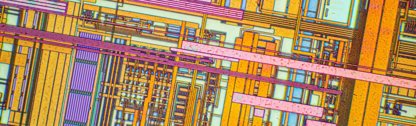 Silicon chip from a computer laser mouse under a microscope. Differential-interference contrast of reflected light. 50x magnification