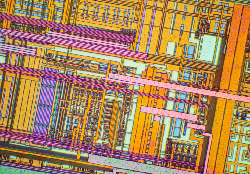Silicon chip from a computer laser mouse under a microscope. Differential-interference contrast of reflected light. 50x magnification